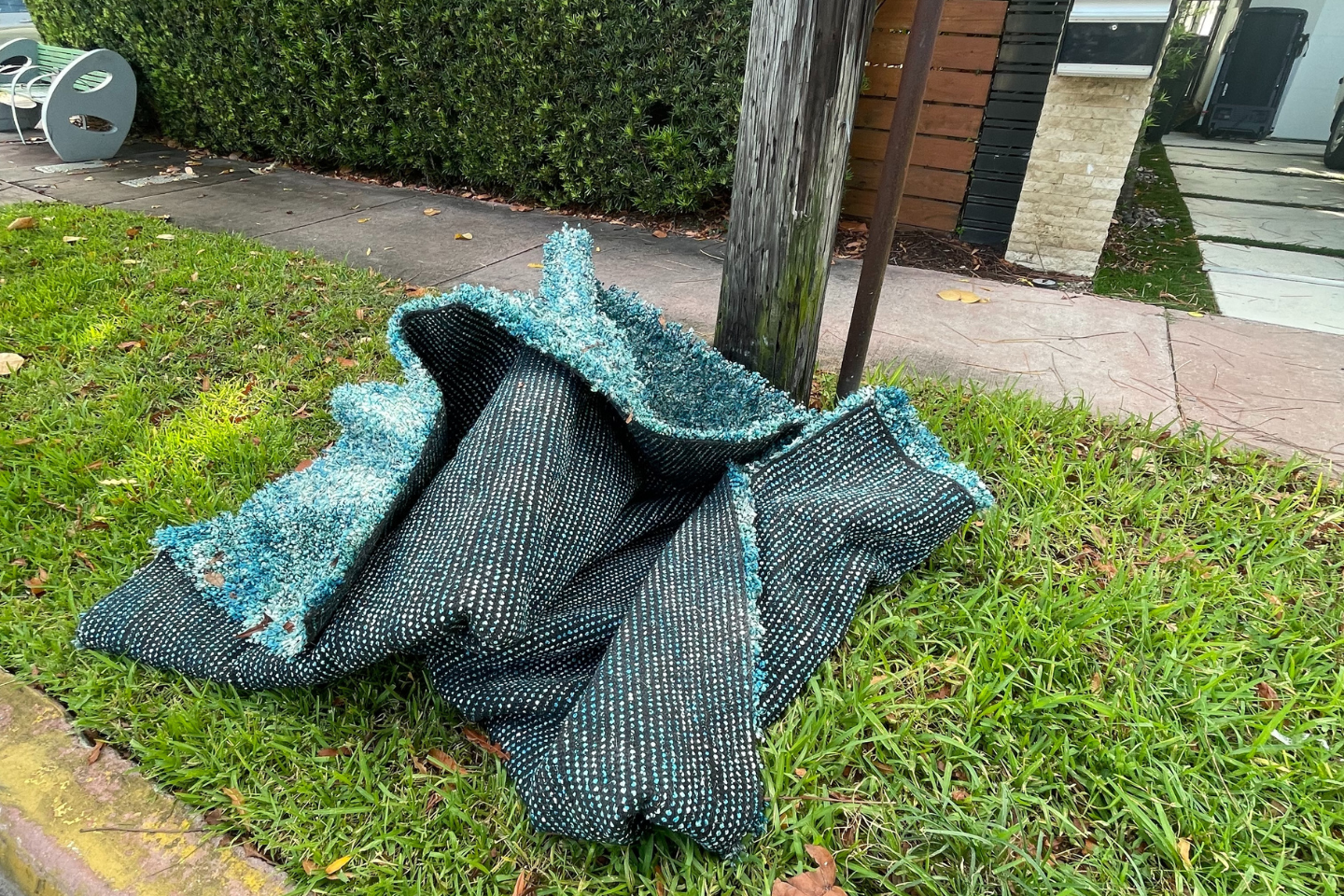 A pile of blue cloth sitting on the grass.